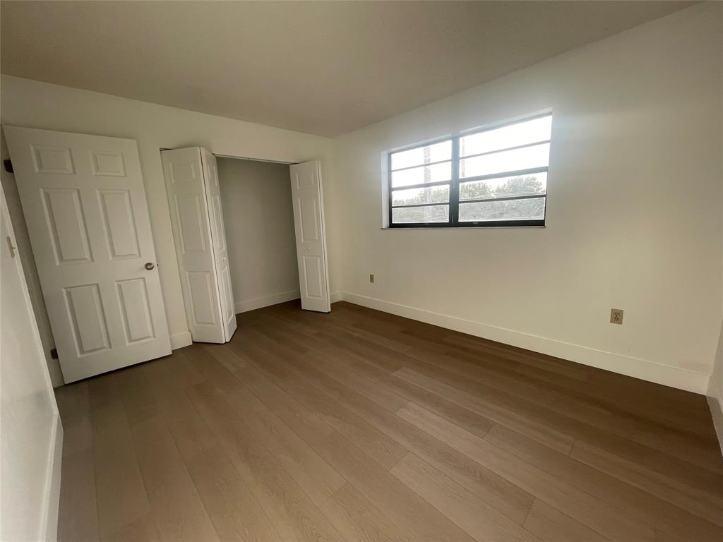 1470 West 41st Street, Unit 201 Hialeah, FL 33012 - Photo 17 of 26 a view of empty room with wooden floor and fan