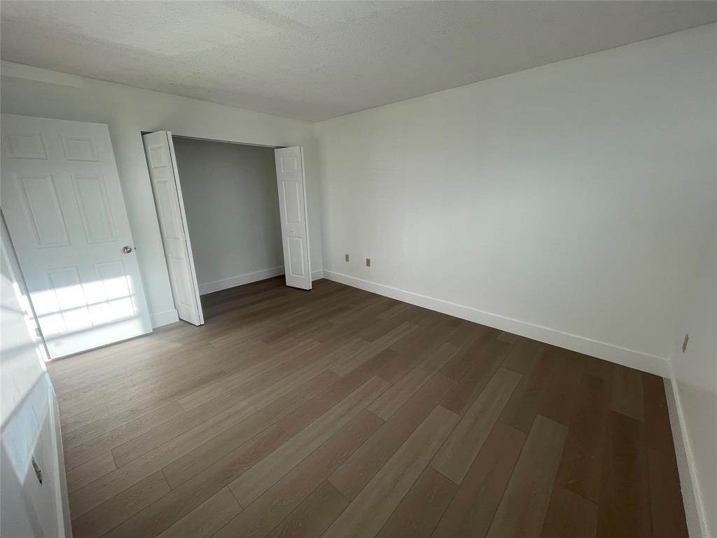 1470 West 41st Street, Unit 201 Hialeah, FL 33012 - Photo 18 of 26 an empty room with wooden floor