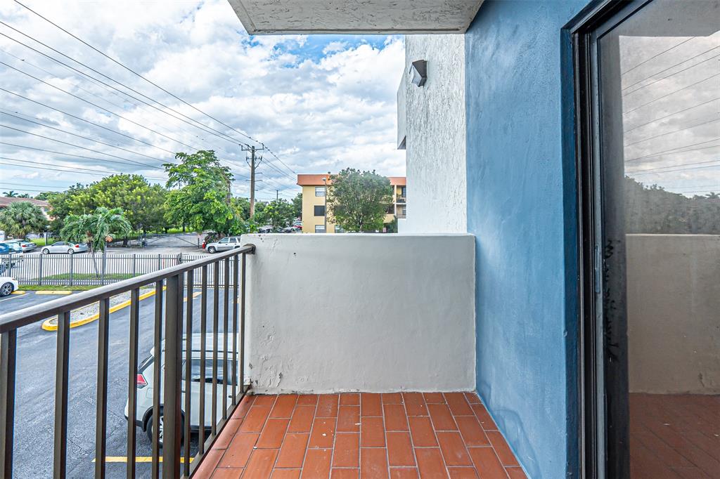 1470 West 41st Street, Unit 201 Hialeah, FL 33012 - Photo 21 of 26 a balcony with wooden floor