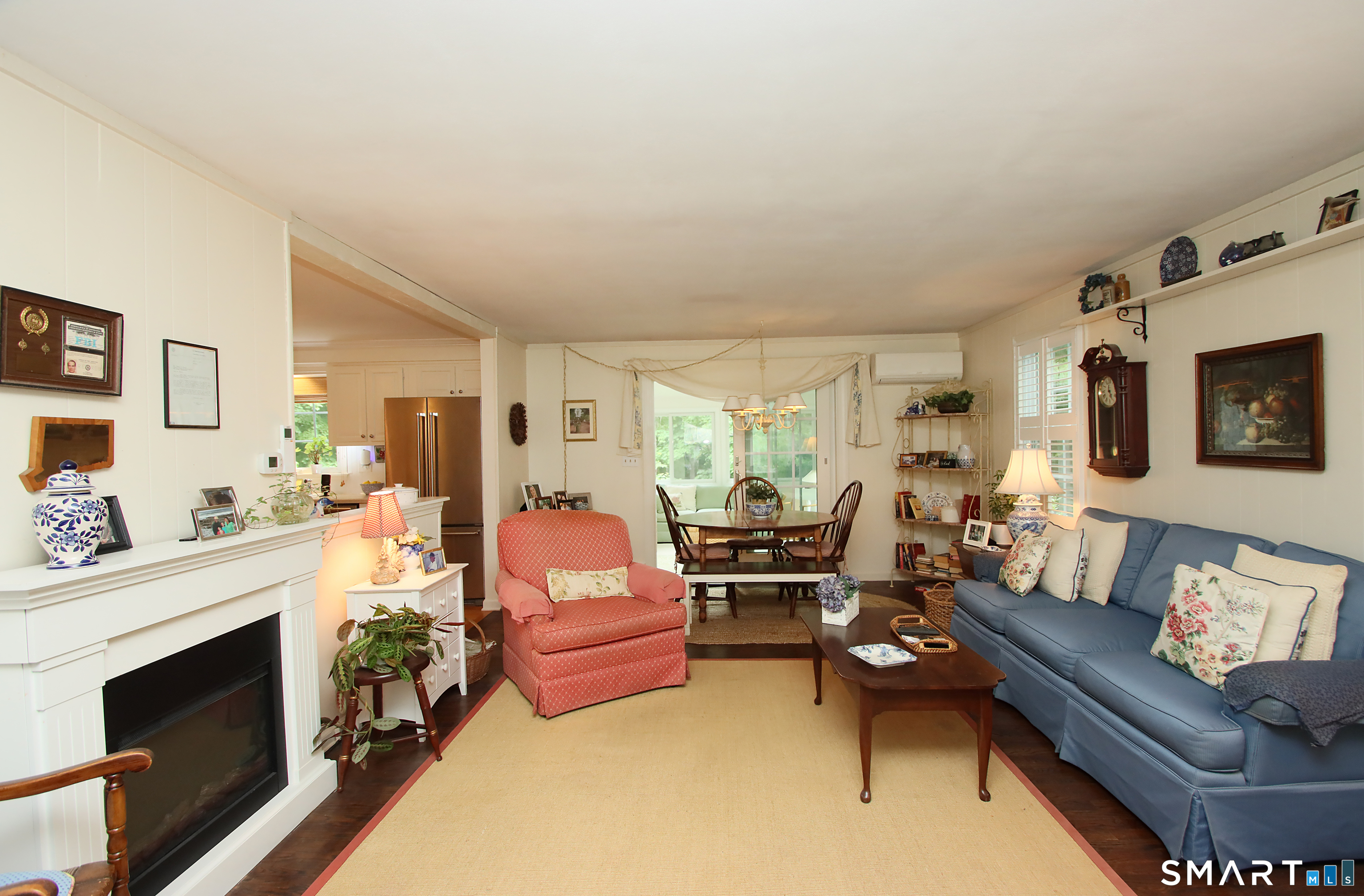 49 Hammonassett Meadows Road Madison, CT 06443 - Photo 14 of 31 Family Room opens to the sunroom. There is no real fireplace in the family room. The one shown is an electric free standing "fireplace"