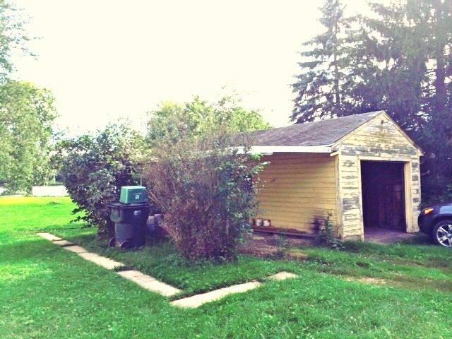28243 West Fox River Road Cary, IL 60013 - Photo 9 of 9 a front view of a house with a garden