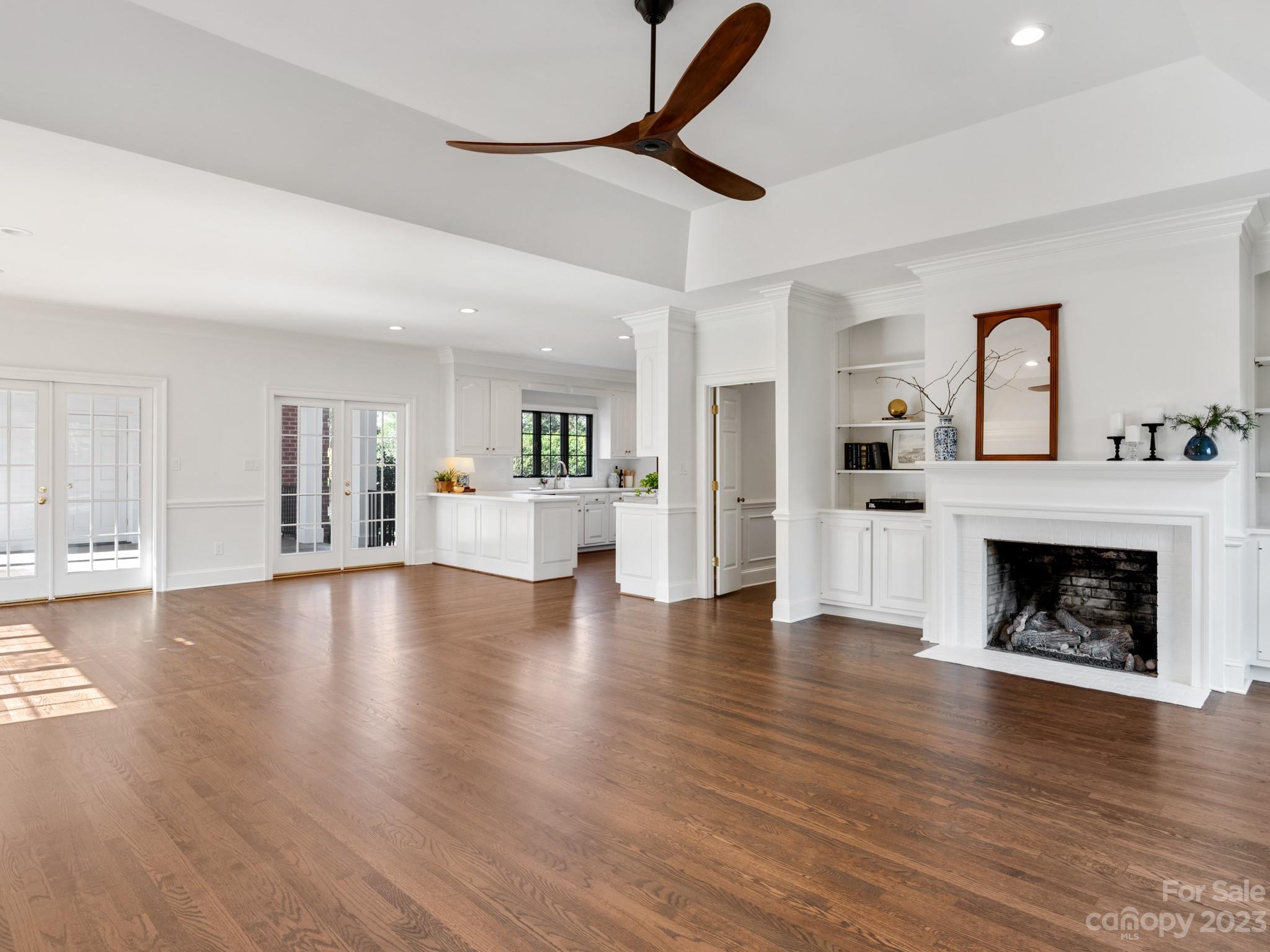 1150 Concord Road Davidson, NC 28036 - Photo 13 of 39 a view of a livingroom with wooden floor and a kitchen