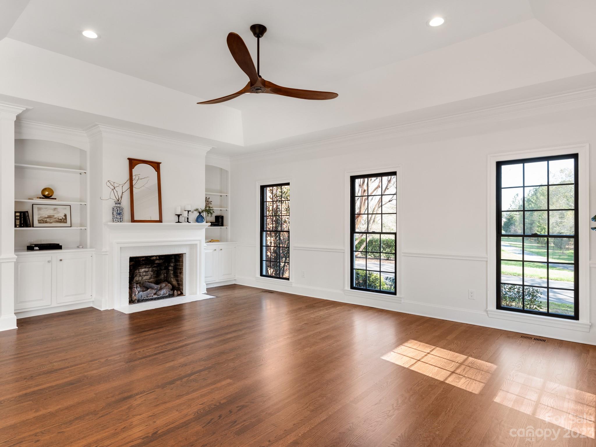 1150 Concord Road Davidson, NC 28036 - Photo 14 of 39 a view of an empty room with wooden floor fireplace and a window