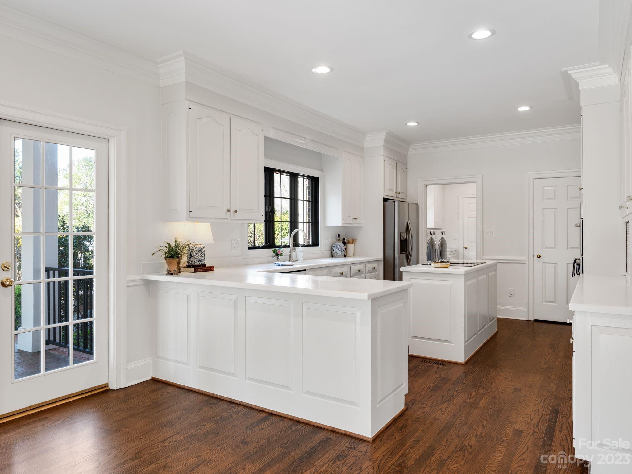 1150 Concord Road Davidson, NC 28036 - Photo 19 of 39 a kitchen with white cabinets and sink