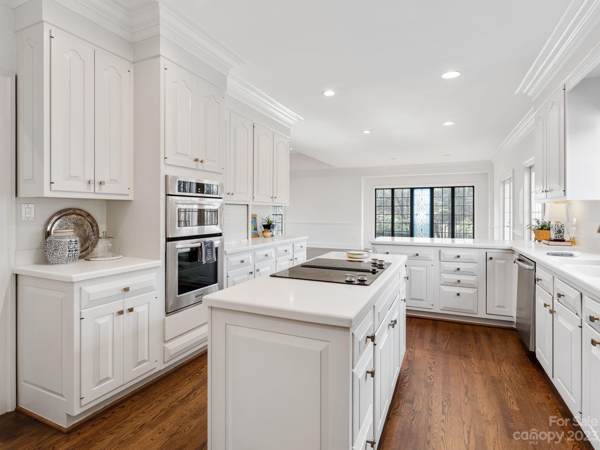1150 Concord Road Davidson, NC 28036 - Photo 20 of 39 a kitchen with white cabinets and white appliances