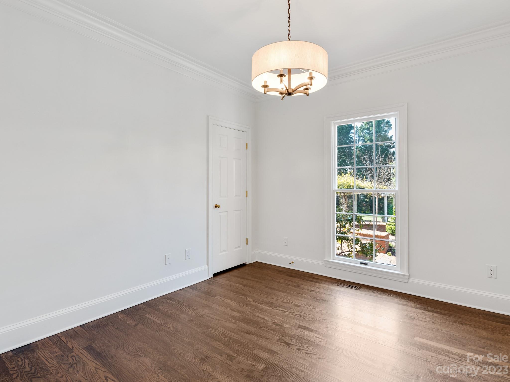 1150 Concord Road Davidson, NC 28036 - Photo 27 of 39 an empty room with wooden floor and windows