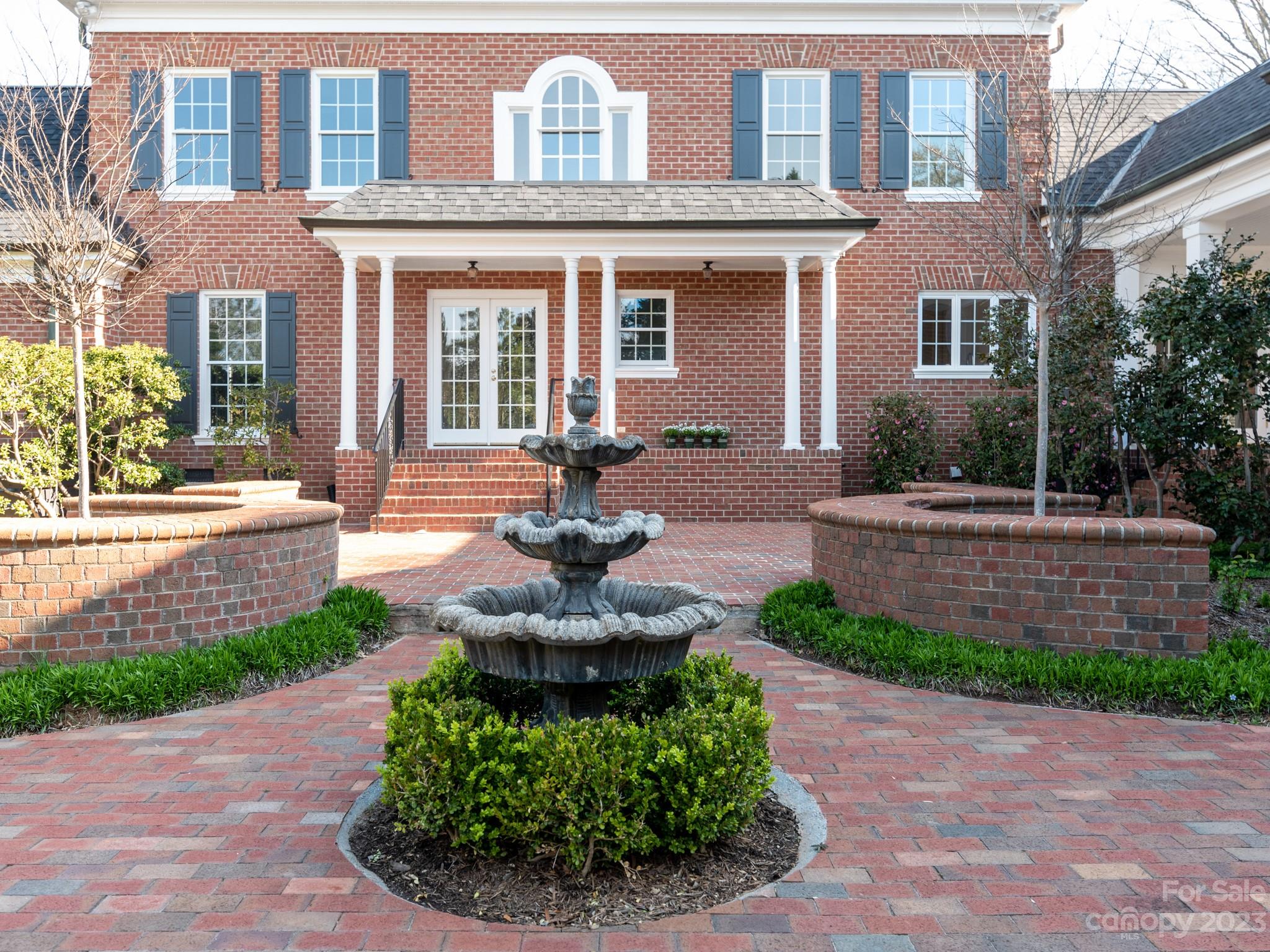 1150 Concord Road Davidson, NC 28036 - Photo 37 of 39 a front view of a house with garden and porch