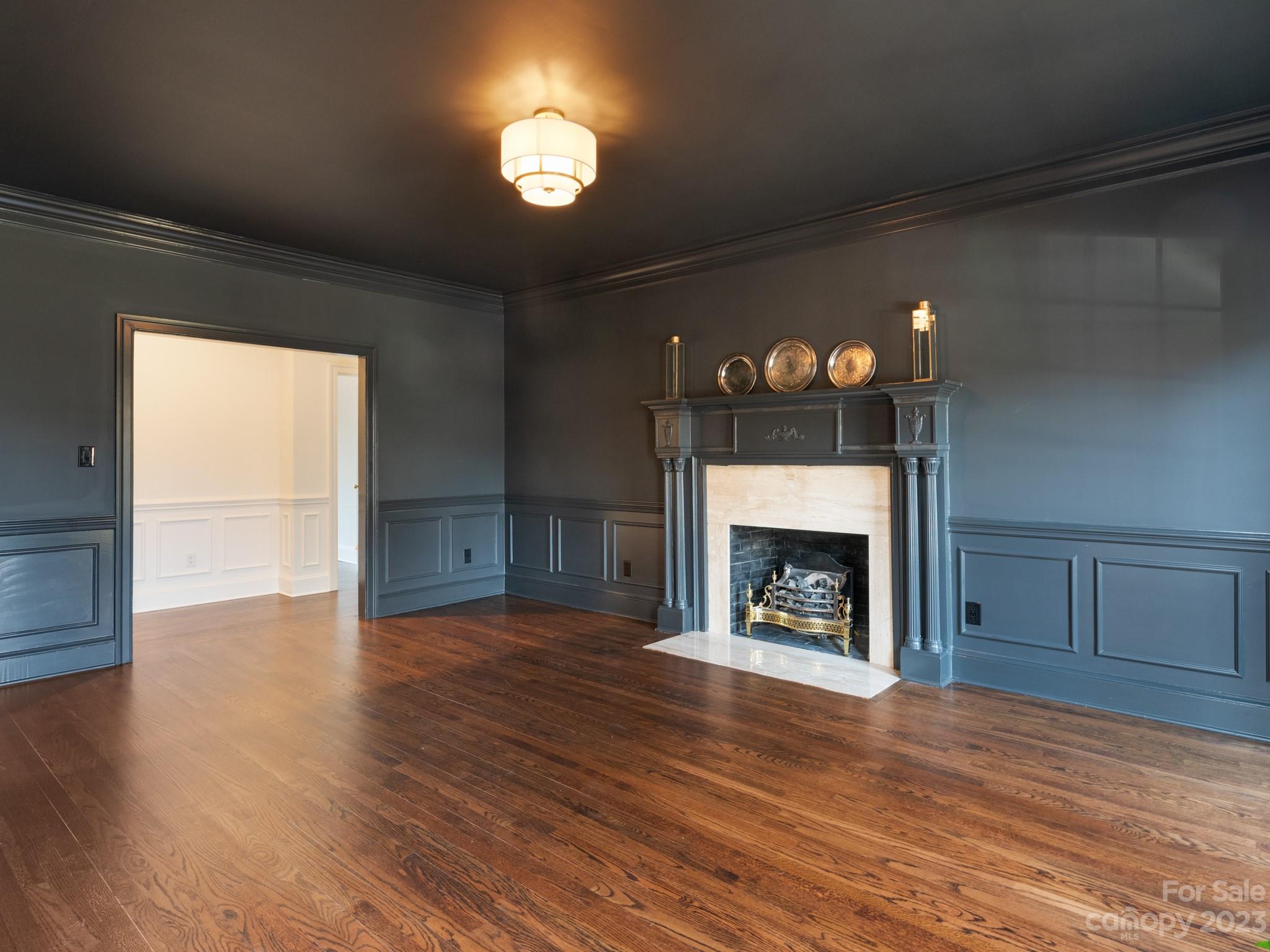 1150 Concord Road Davidson, NC 28036 - Photo 7 of 39 an empty room with wooden floor fireplace and window
