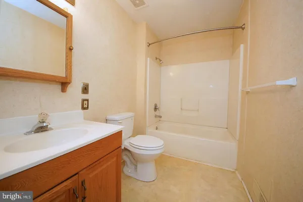 a living room with furniture a ceiling fan and a window