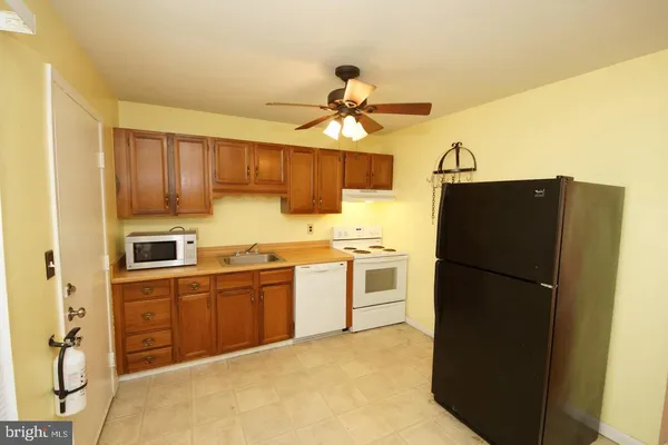 a kitchen that has a sink and a stove