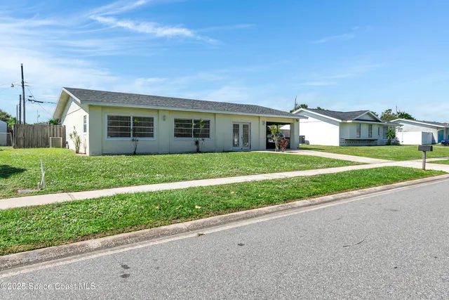 a front view of house with yard and green space