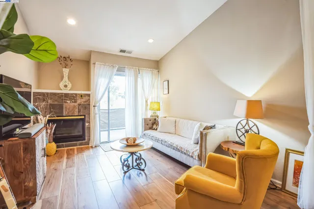 a living room with furniture and a fireplace