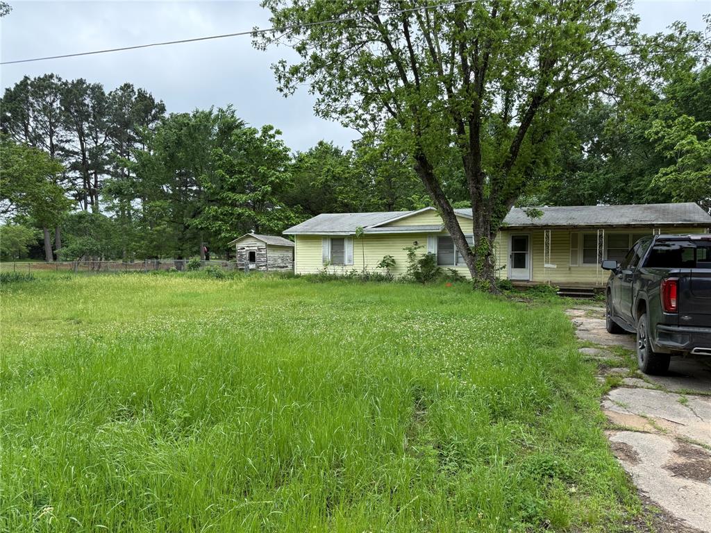 a view of an house with backyard space and sitting area