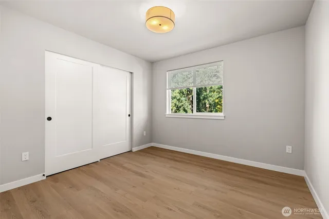 a view of room with window and wooden floor