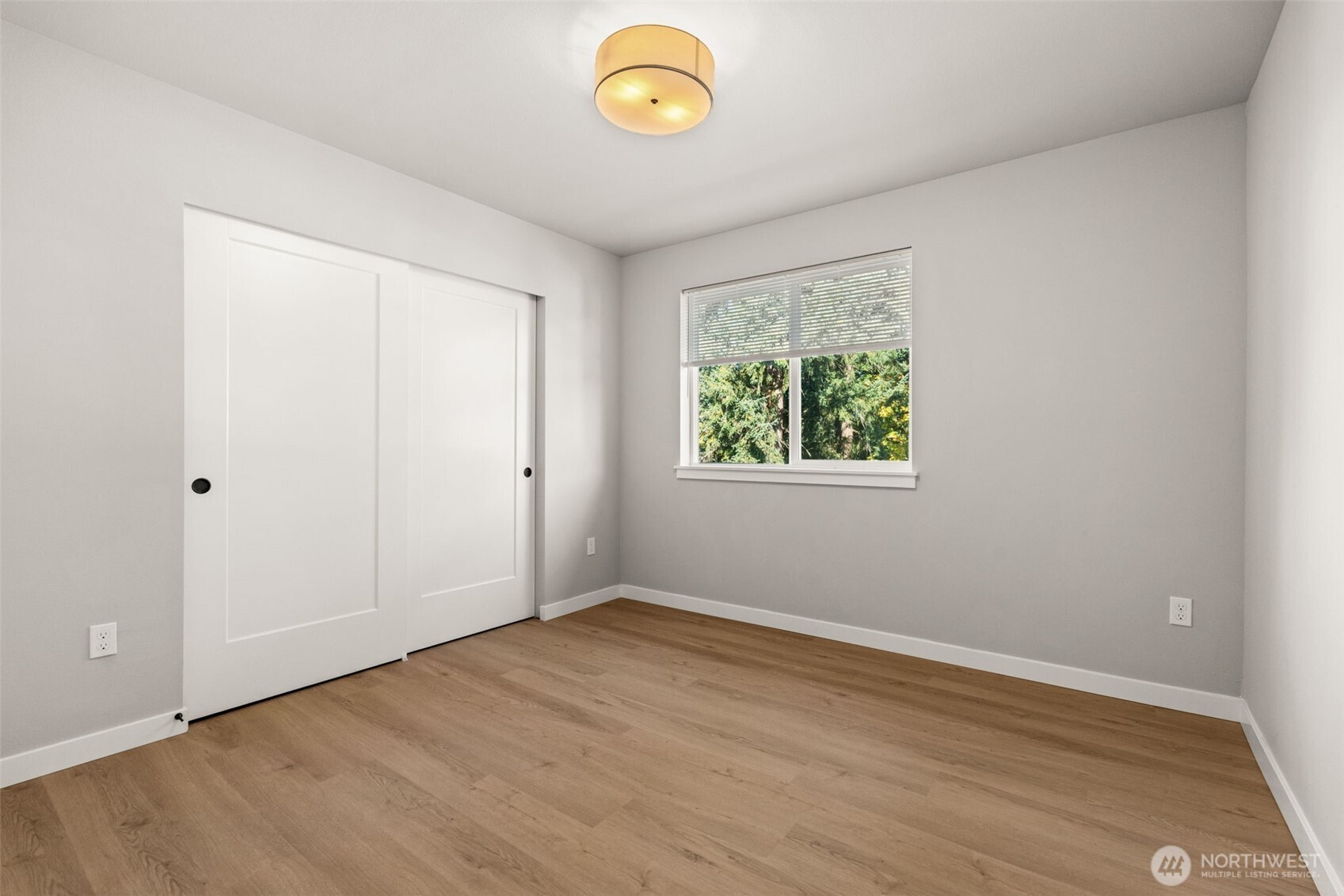 304 118th Street South, Unit 4 Tacoma, WA 98444 - Photo 18 of 37 a view of room with window and wooden floor