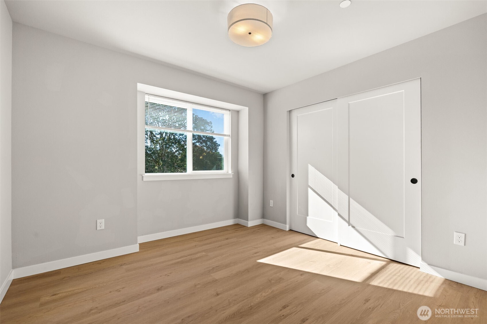 304 118th Street South, Unit 4 Tacoma, WA 98444 - Photo 21 of 37 an empty room with wooden floor and windows