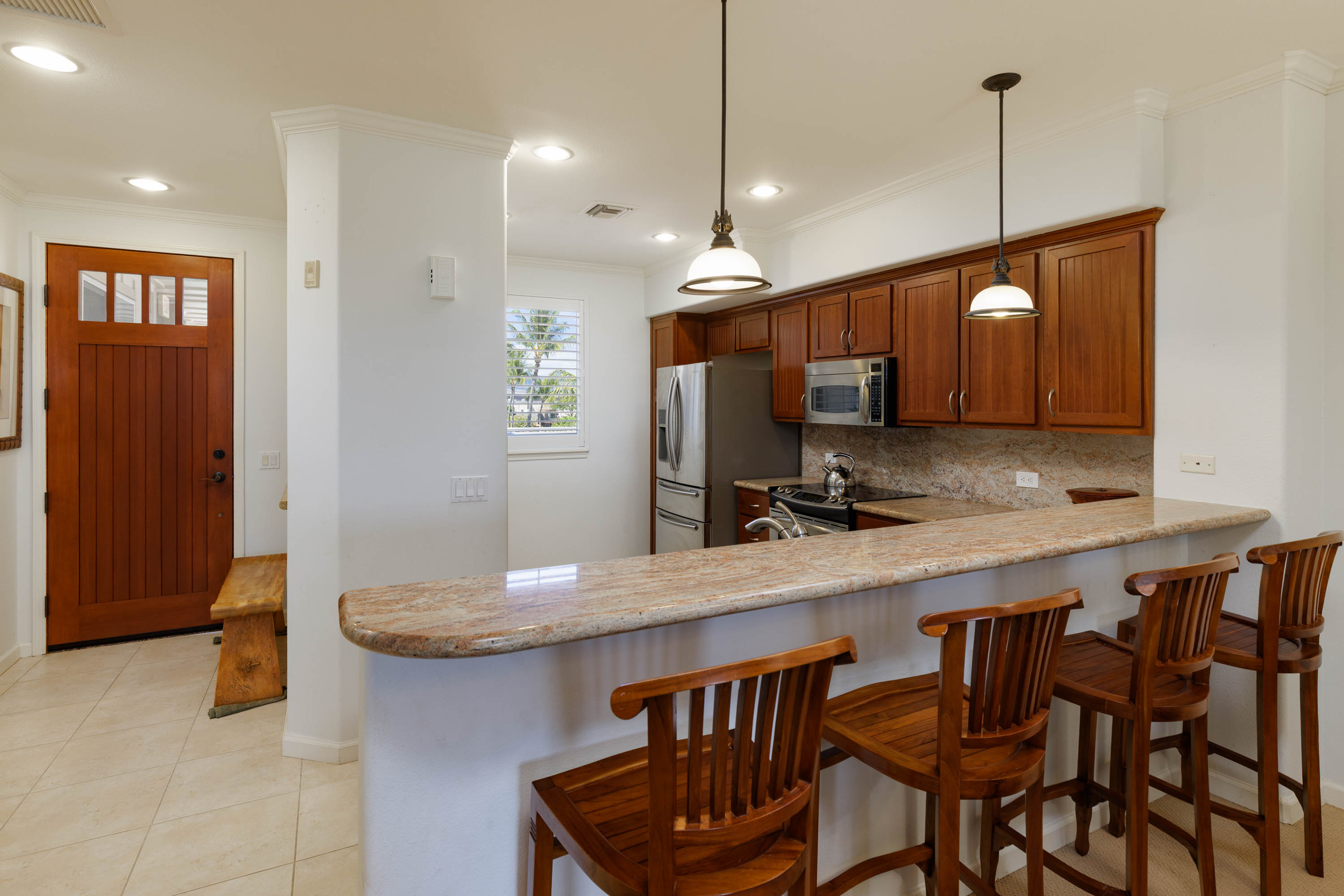 69-180 Waikoloa Beach Drive, Unit G33 Waikoloa, HI 96738 - Photo 2 of 30 a kitchen with a table and chairs in it