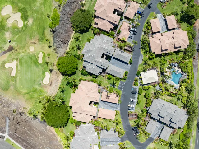 an aerial view of a house with a yard