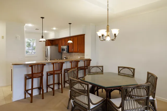 a view of a dining room with furniture and a chandelier