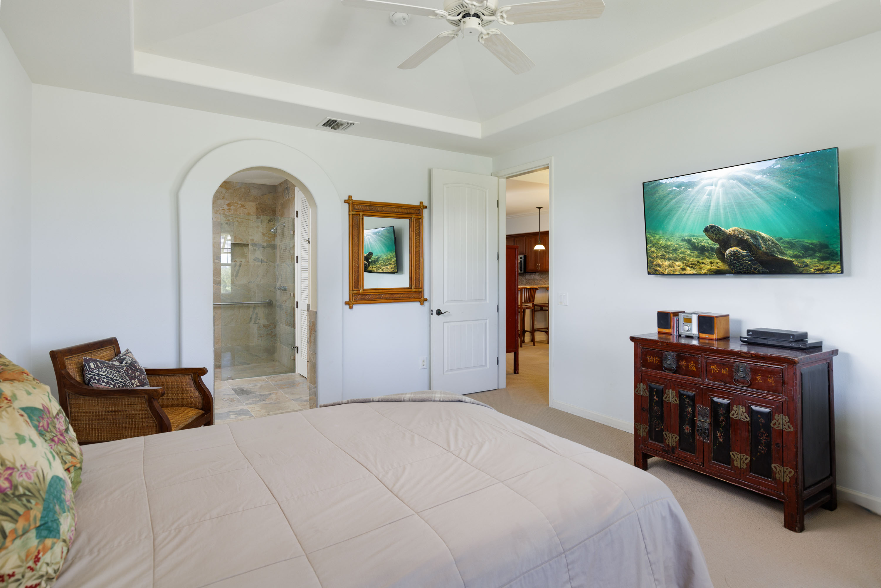 69-180 Waikoloa Beach Drive, Unit G33 Waikoloa, HI 96738 - Photo 8 of 30 a bedroom with furniture and a flat screen tv