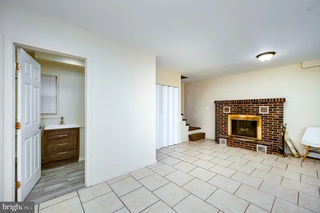 a view of an empty room and fire place