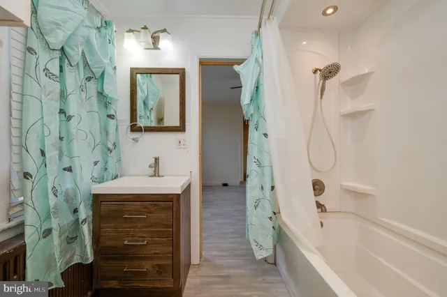 a bathroom with a granite countertop sink a toilet and shower