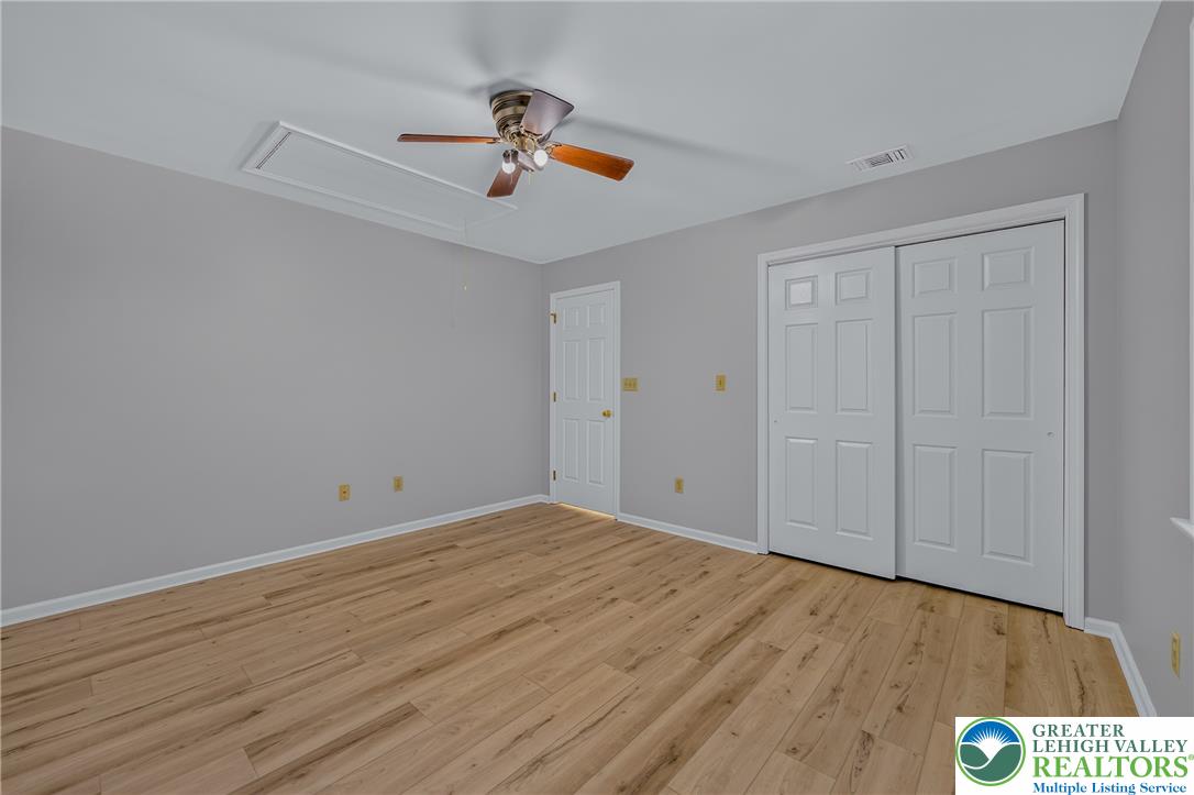 630 Clearfield Road Nazareth, PA 18064 - Photo 62 of 100 Gleaming wood-inspired floors and clean neutral walls define this versatile secondary bedroom space.