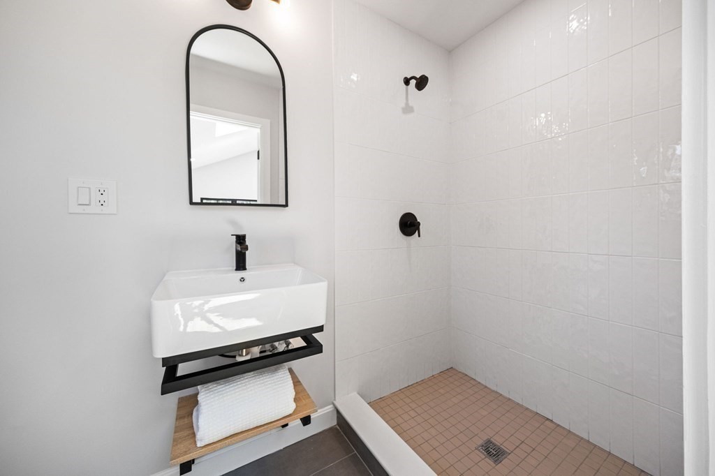 9-11 Glazer Road, Unit 11 Newton, MA 02459 - Photo 27 of 31 a bathroom with a sink and a mirror