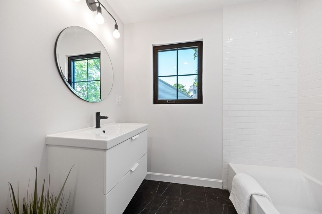 9-11 Glazer Road, Unit 11 Newton, MA 02459 - Photo 28 of 31 a bathroom with a sink and a mirror