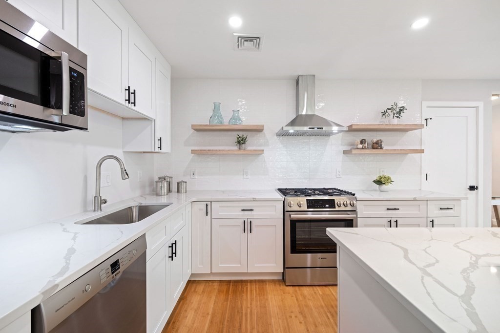 9-11 Glazer Road, Unit 11 Newton, MA 02459 - Photo 6 of 31 a kitchen with white cabinets stainless steel appliances and sink