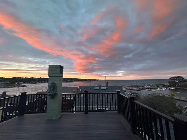 an aerial view of a house with a garden and lake view
