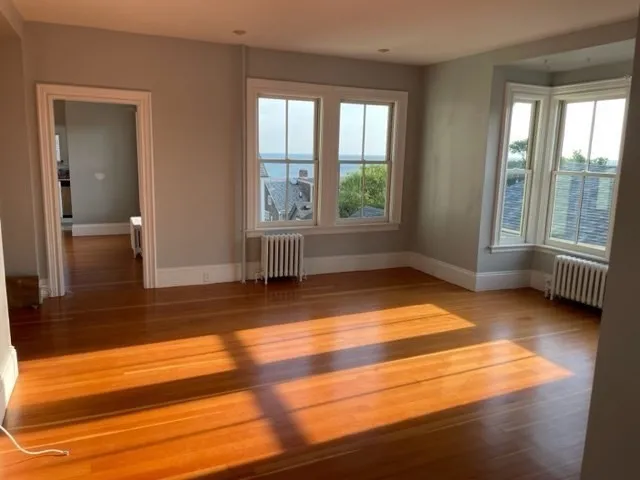 a view of a balcony with two chairs and a potted plant