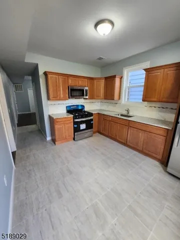 a kitchen with stainless steel appliances granite countertop a sink and a dishwasher