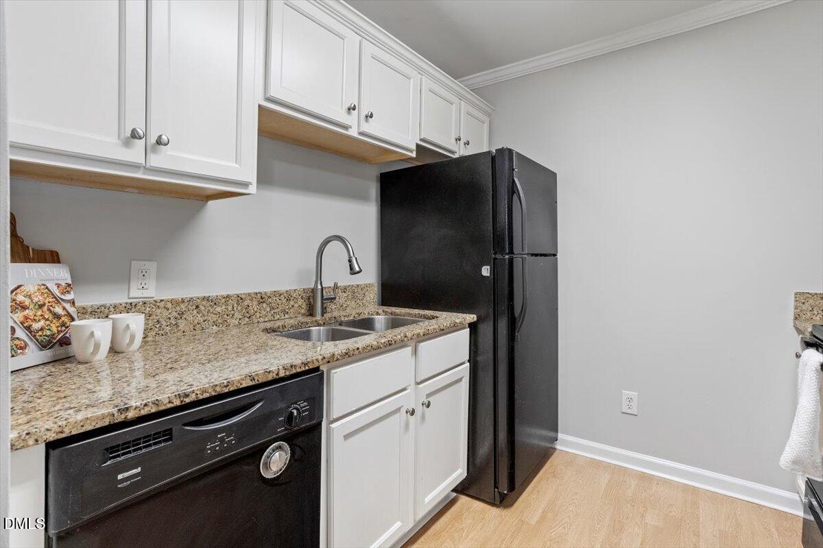 2308 Myron Drive, Unit 201 Raleigh, NC 27607 - Photo 11 of 29 a kitchen with granite countertop white cabinets and a sink