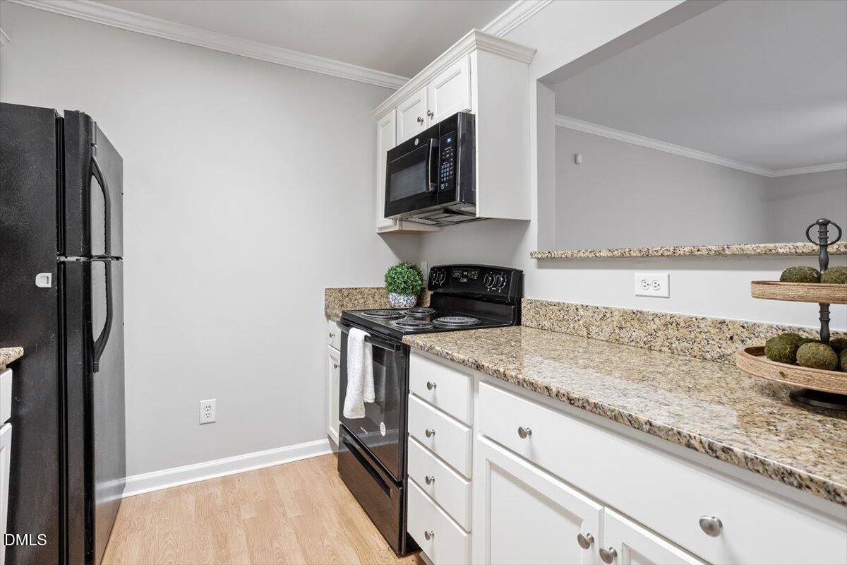 2308 Myron Drive, Unit 201 Raleigh, NC 27607 - Photo 12 of 29 a kitchen with stainless steel appliances granite countertop a sink stove and refrigerator