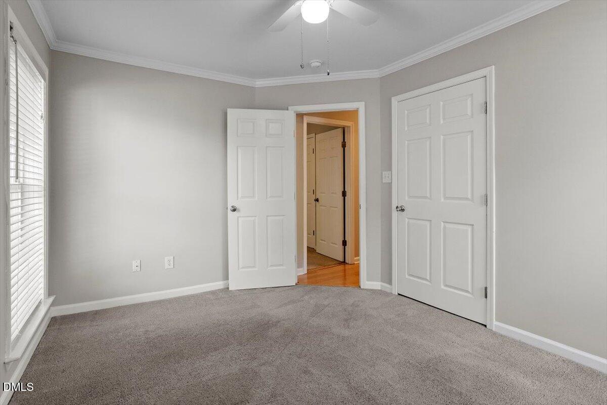 2308 Myron Drive, Unit 201 Raleigh, NC 27607 - Photo 20 of 29 an empty room with a ceiling fan and a window