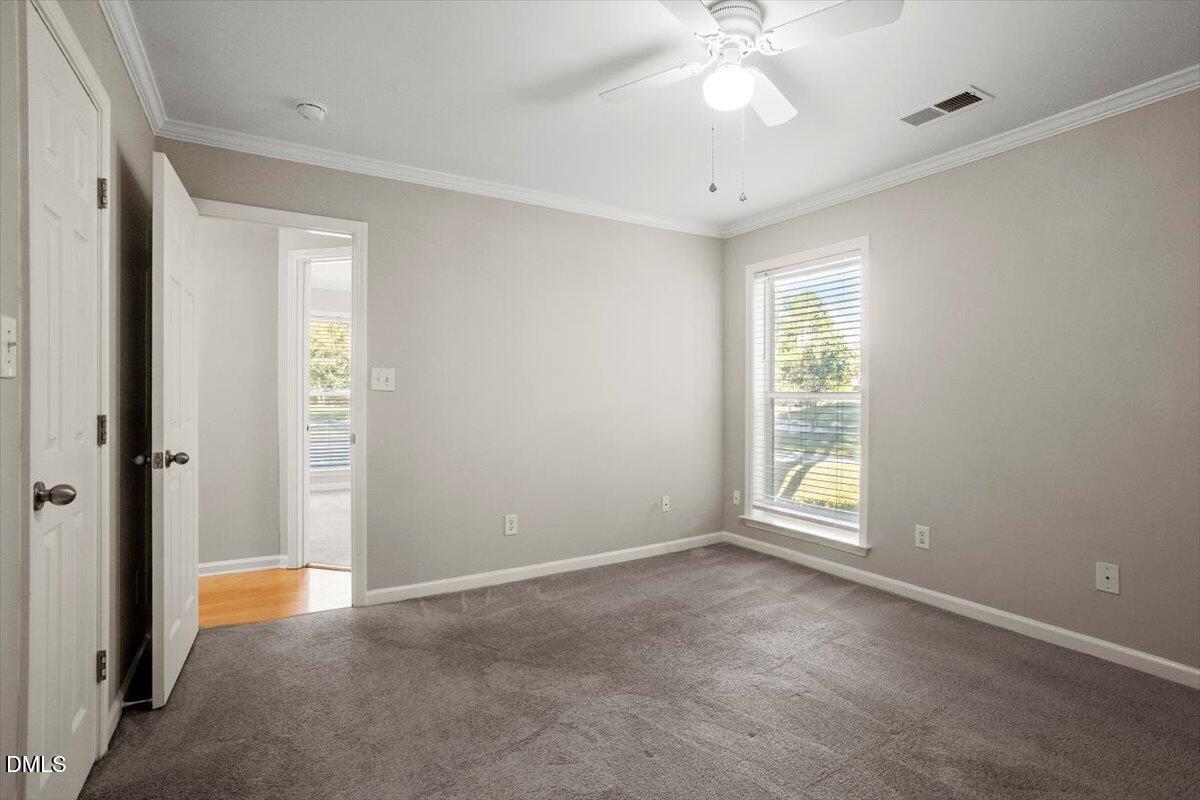 2308 Myron Drive, Unit 201 Raleigh, NC 27607 - Photo 26 of 29 an empty room with fan and windows