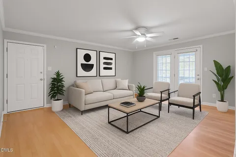 a living room with furniture potted plant and window