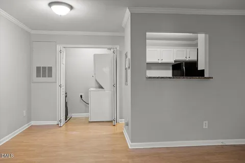 a view of empty room with wooden floor and cabinet