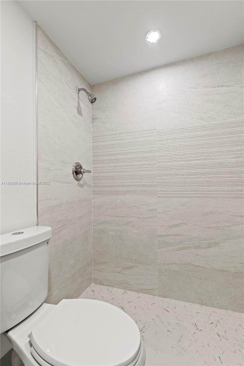 Pinewood Miami, FL 33150 - Photo 11 of 20 a bathroom with a toilet and a shower
