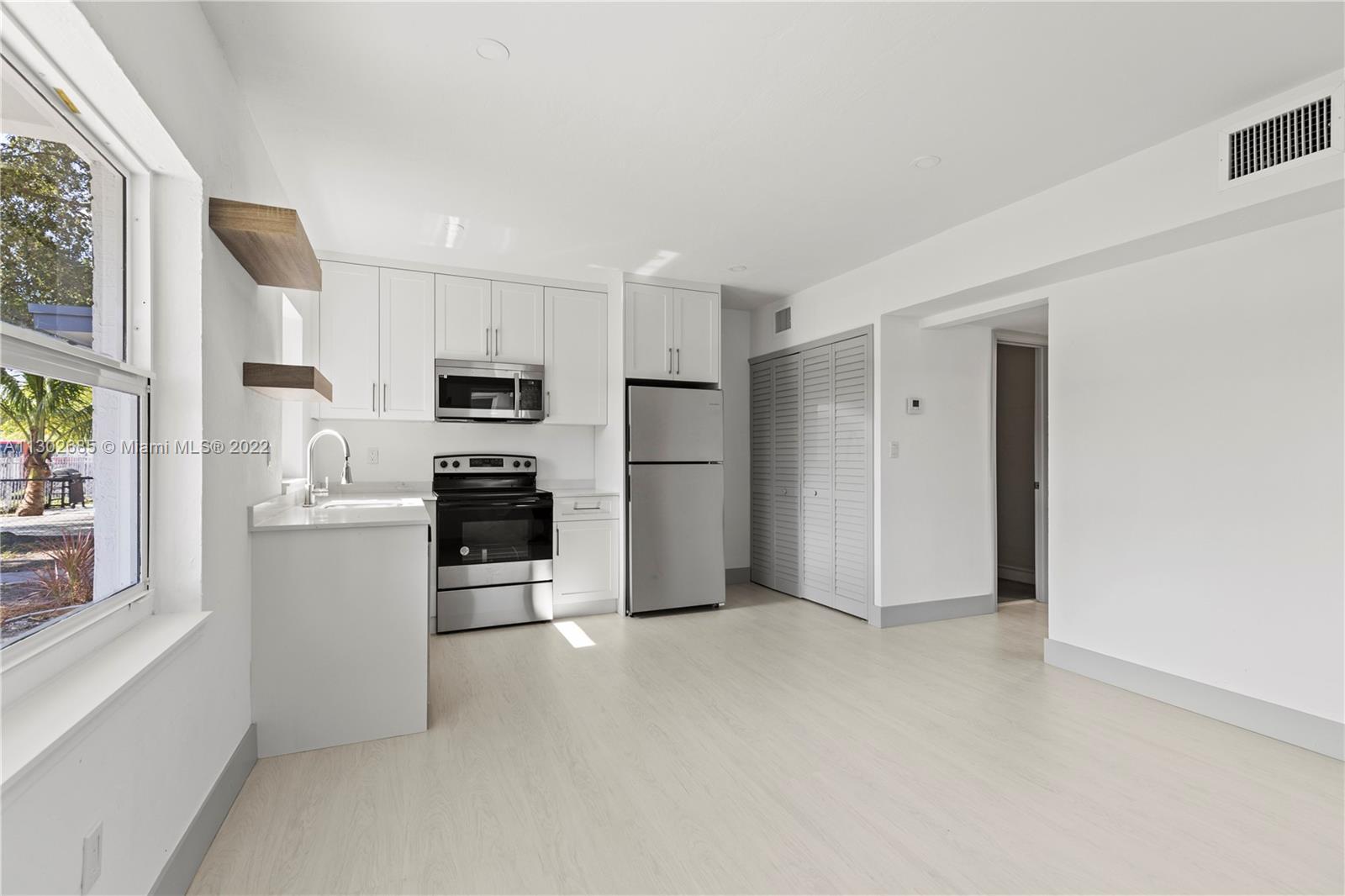 Pinewood Miami, FL 33150 - Photo 12 of 20 a view of a kitchen with a sink stove refrigerator and window