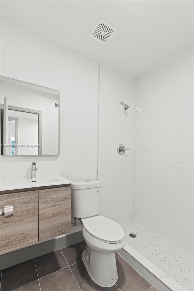 Pinewood Miami, FL 33150 - Photo 15 of 20 a bathroom with a sink a toilet and shower