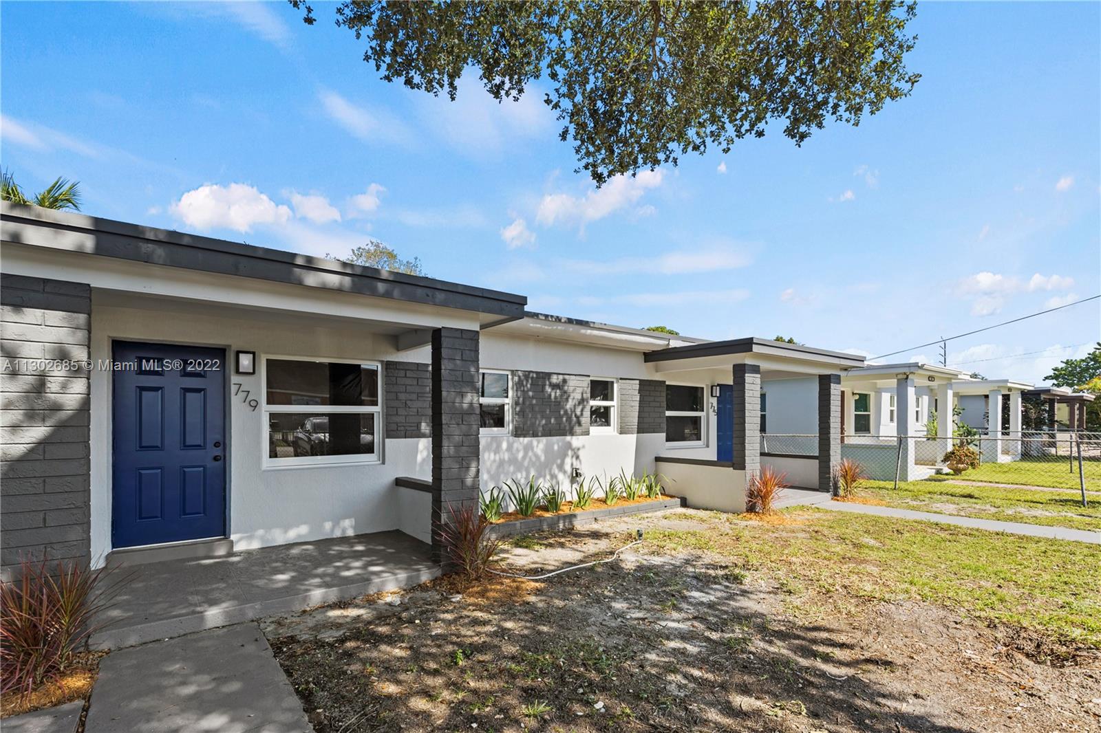 Pinewood Miami, FL 33150 - Photo 2 of 20 a front view of a house with a yard outdoor seating and garage