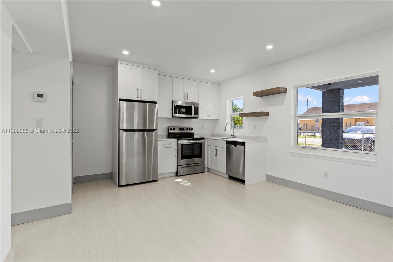 Pinewood Miami, FL 33150 - Photo 4 of 20 a kitchen with stainless steel appliances a refrigerator and a stove top oven