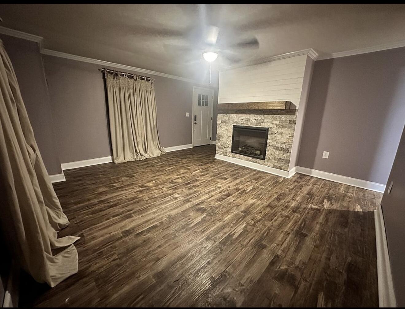 120 7th Street Calhoun, TN 37309 - Photo 2 of 17 a view of an empty room with wooden floor fireplace and a window