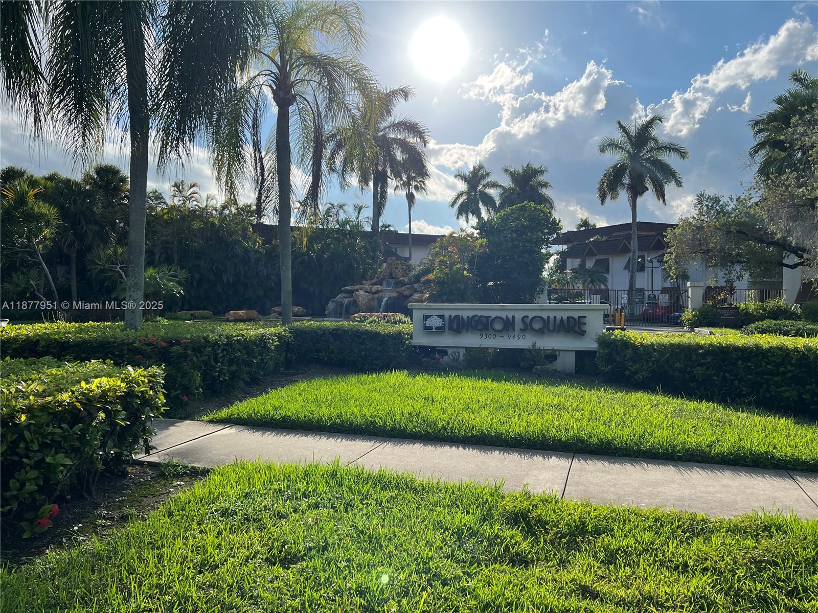 9472 Southwest 77th Avenue, Unit P3 Miami, FL 33156 - Photo 1 of 6 a front view of a house with a yard and potted plants