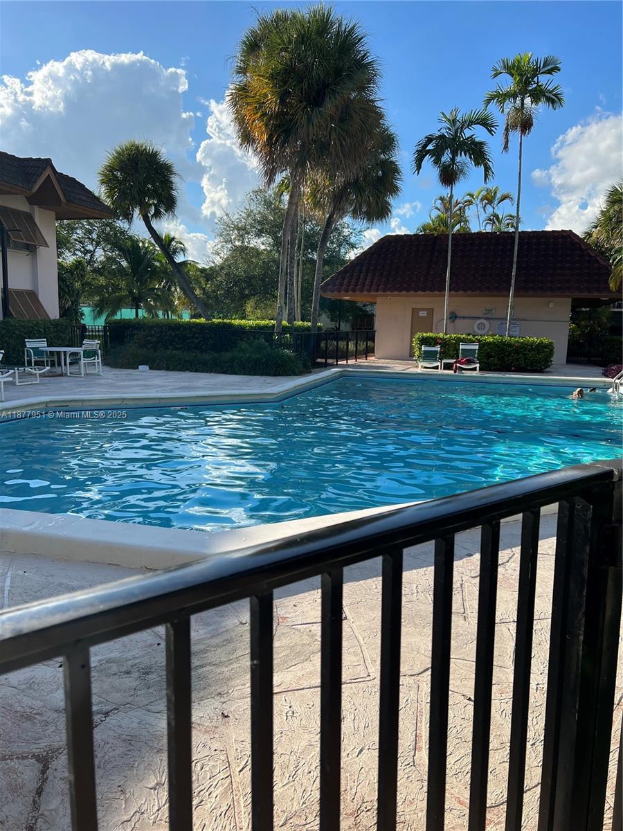 9472 Southwest 77th Avenue, Unit P3 Miami, FL 33156 - Photo 2 of 6 a view of a wooden deck and a lake