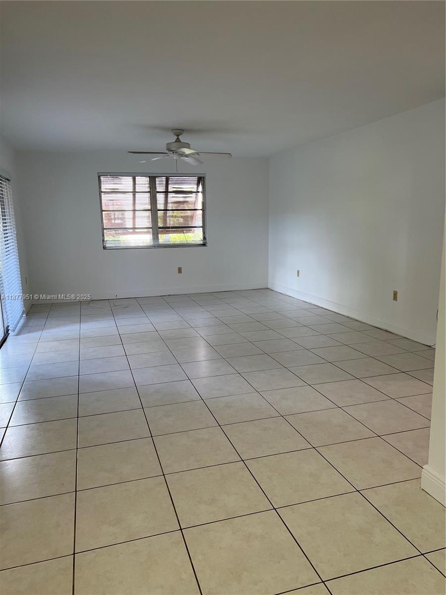 9472 Southwest 77th Avenue, Unit P3 Miami, FL 33156 - Photo 3 of 6 a view of an empty room and window