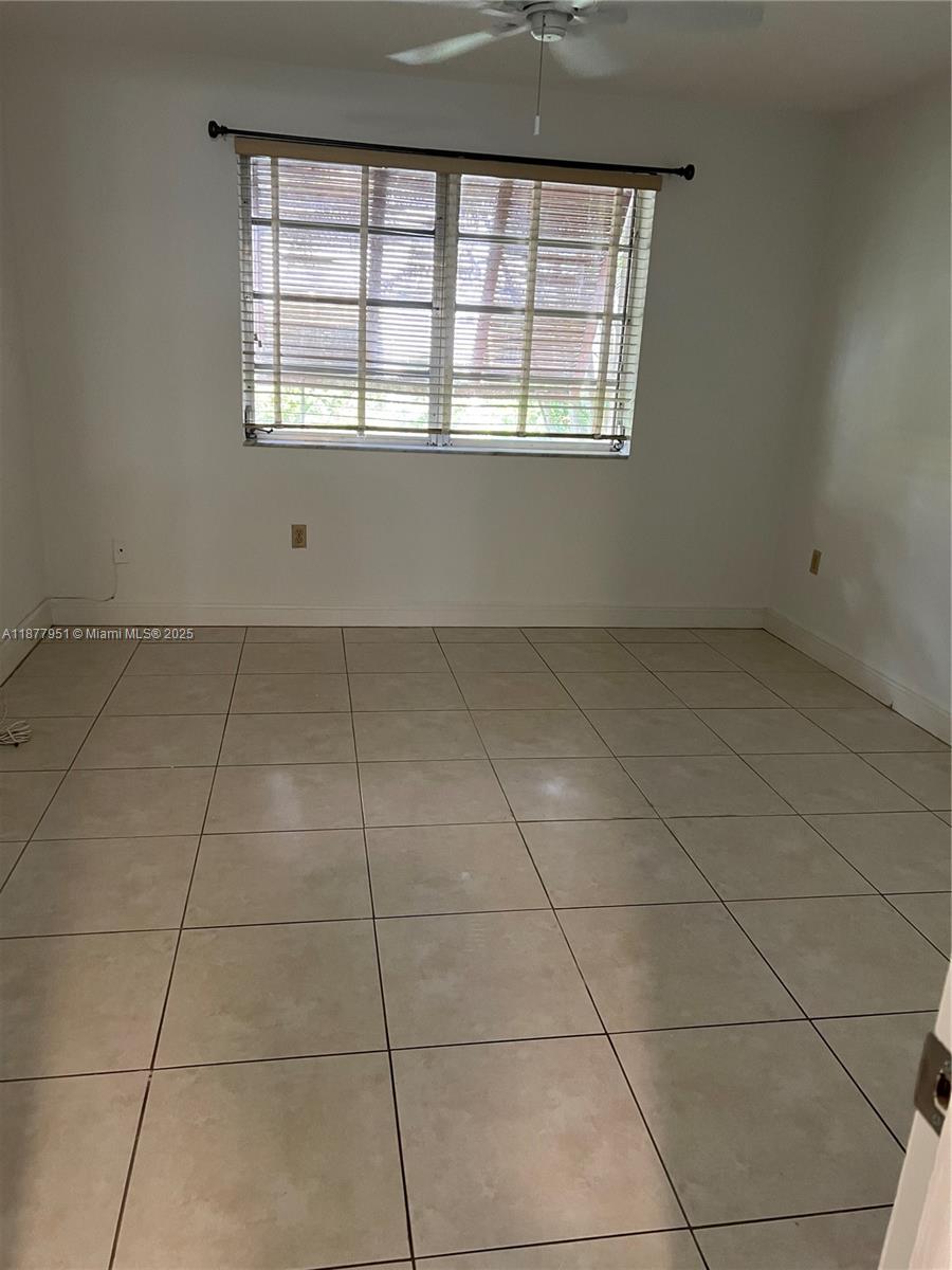 9472 Southwest 77th Avenue, Unit P3 Miami, FL 33156 - Photo 6 of 6 a view of an empty room with a window