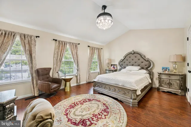 a bedroom with bed and a large window